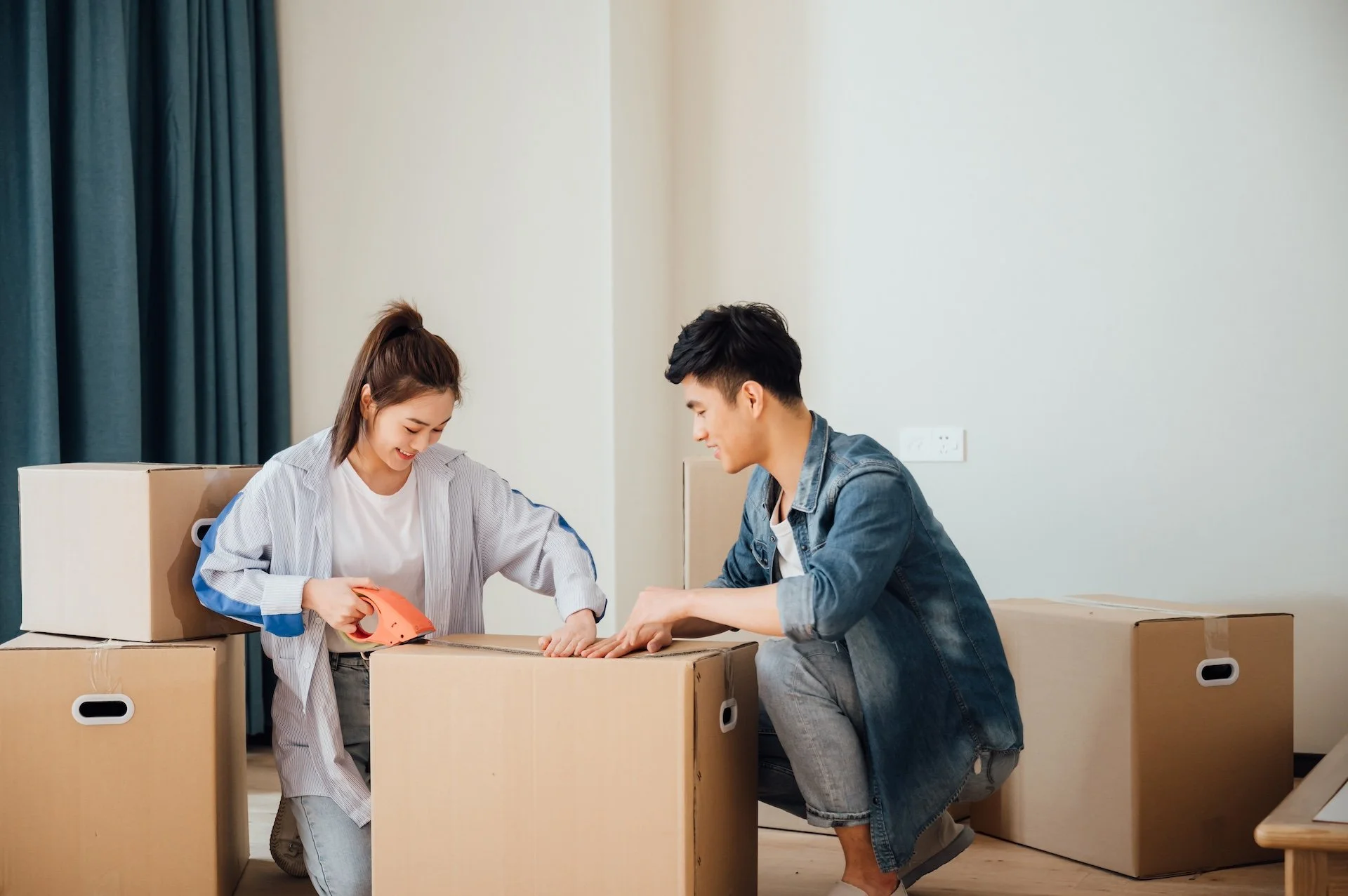 move out cleaning: move-in and move-out cleaning: A couple packing boxes for a move
